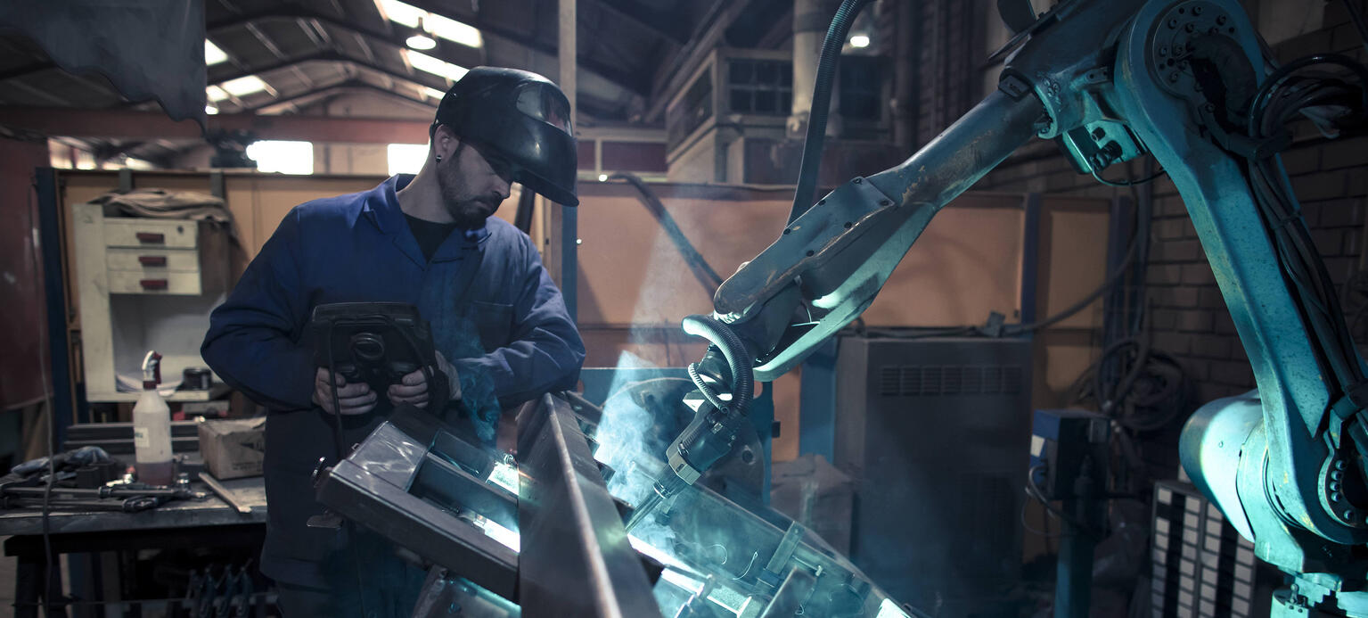 Welder welding metal with robot
