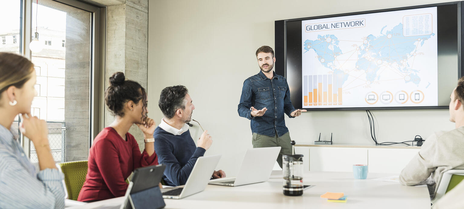 Young businessman leading a presentation in boardroom