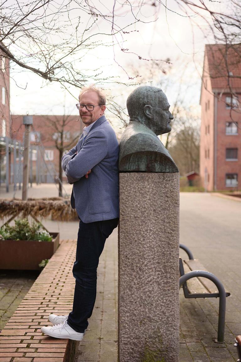 TOBIAS BERGMANN, Oberbürgermeister von Neumünster, Rücken an Rücken mit der Büste von Hans Böckler