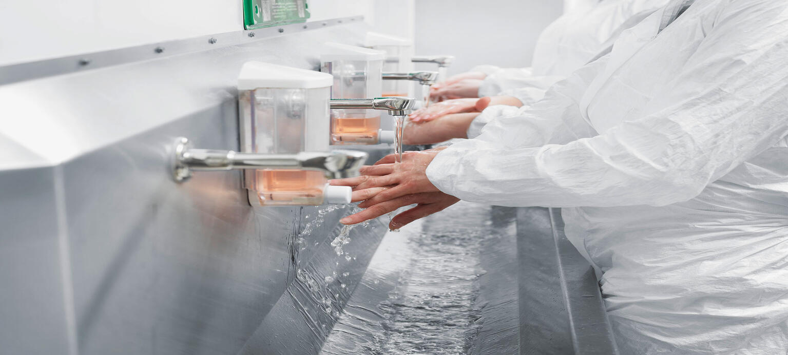 Scientists washing their hands in sink 