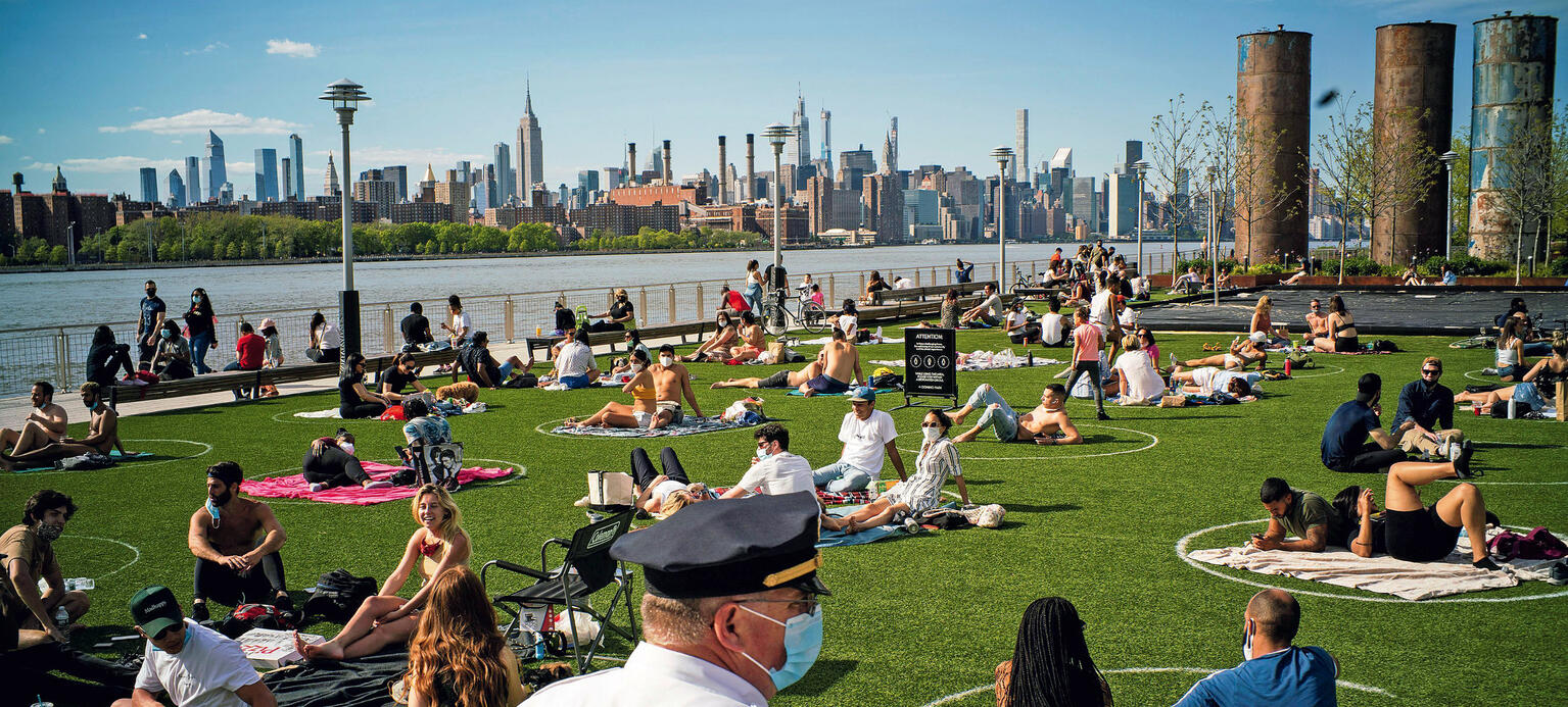 Menschen halten Abstand im Domino Park in New York an einem warmen Frühlingstag während der Corona-Krise.