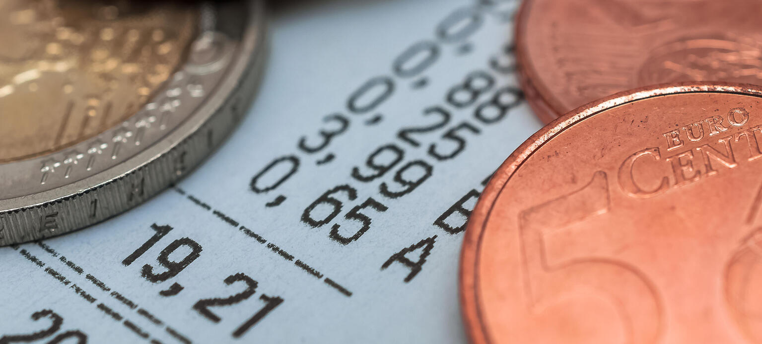 Foto: Kassenbon mit Centmünzen darauf